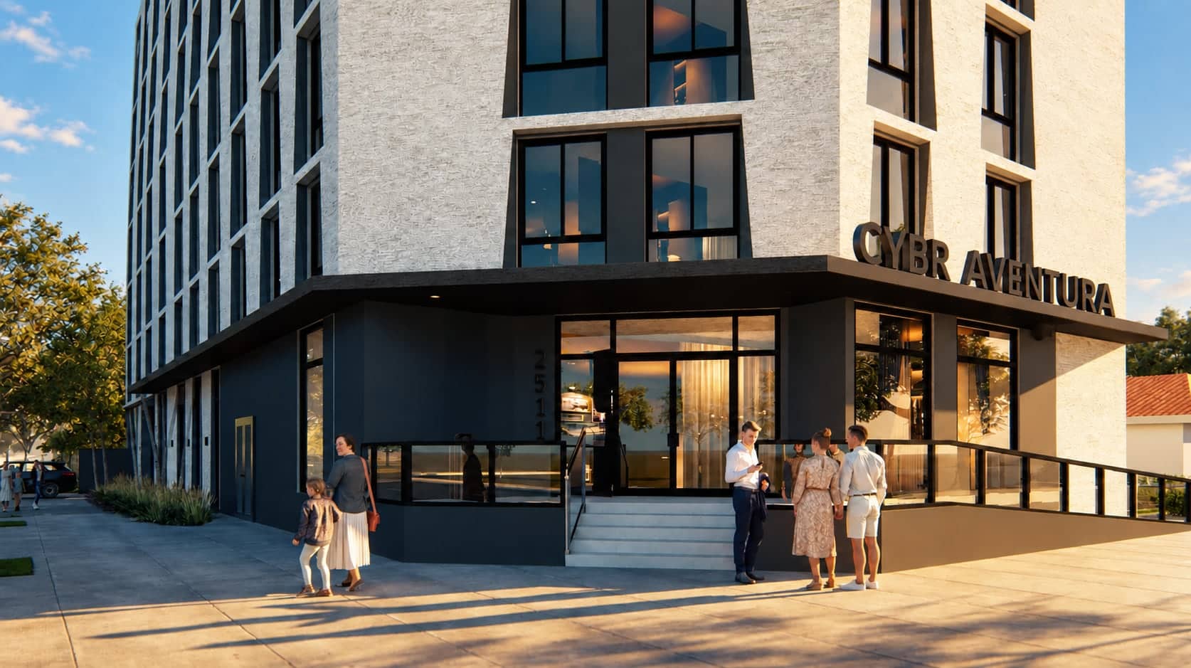The ground-floor corner entry and lobby glazing in daylight, with people on the steps.