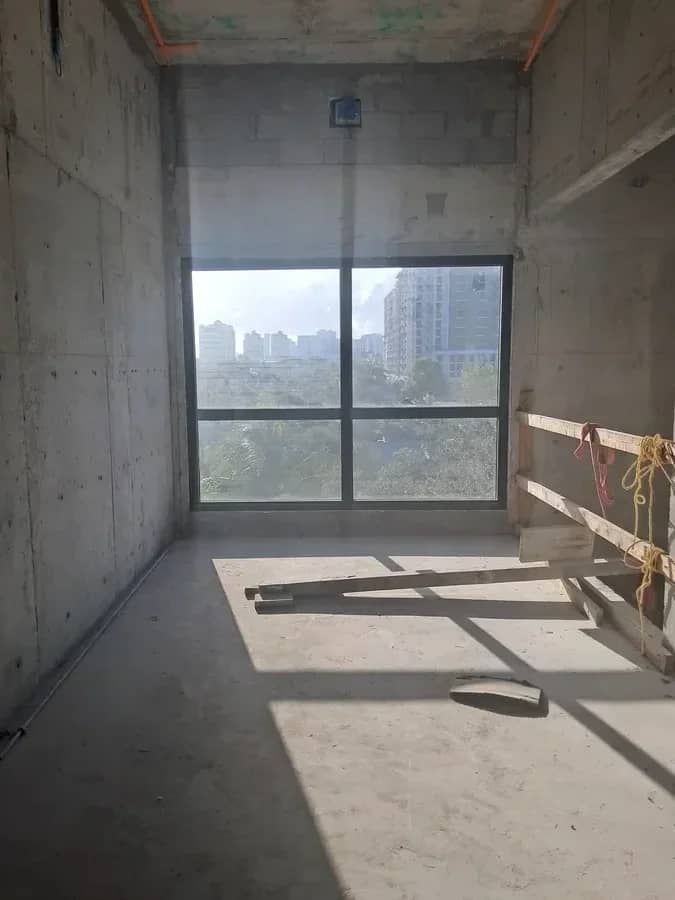 Aventura Quattro, photographed 16 June 2025: a unit shell with concrete walls and the window set, the skyline beyond.