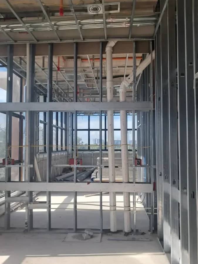 Aventura Quattro, photographed 22 July 2025: stud framing with plumbing risers and window wall.