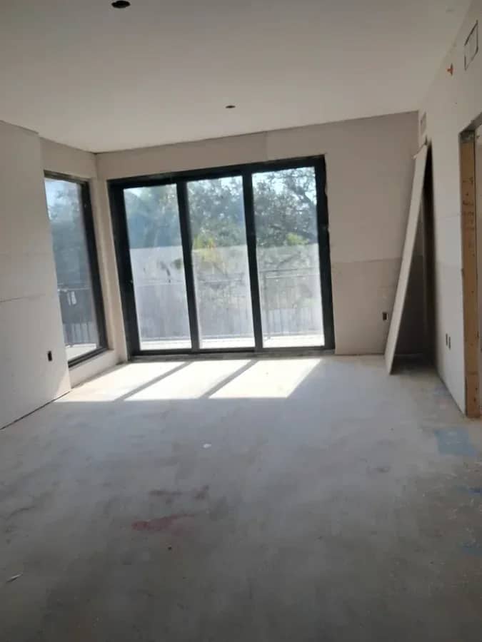 Aventura Quattro, photographed 22 August 2025: drywall hung and sliding doors in, before any finishes.