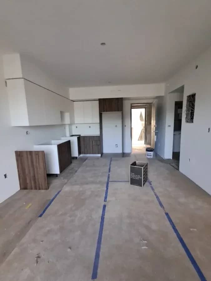 Aventura Quattro, photographed 22 September 2025: kitchen casework being set, floor protection down.