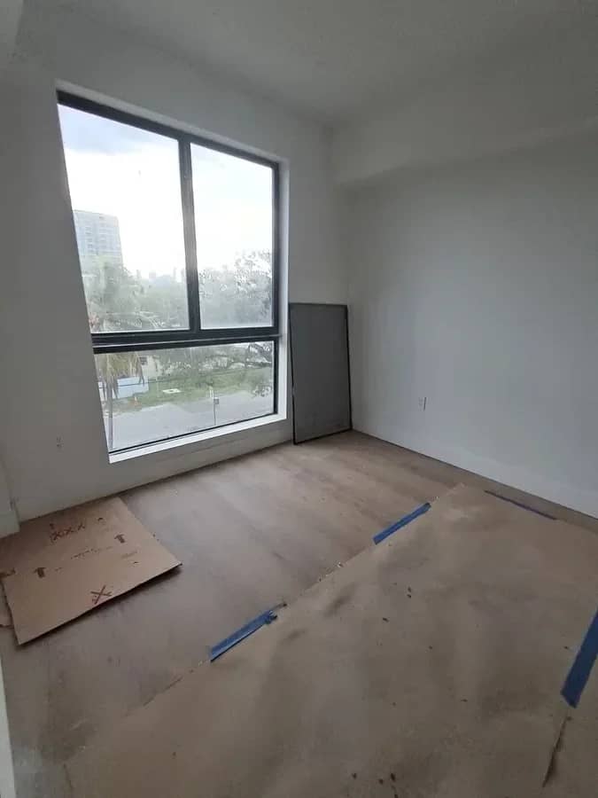 Aventura Quattro, photographed 3 November 2025: plank flooring going down beside a full-height window.