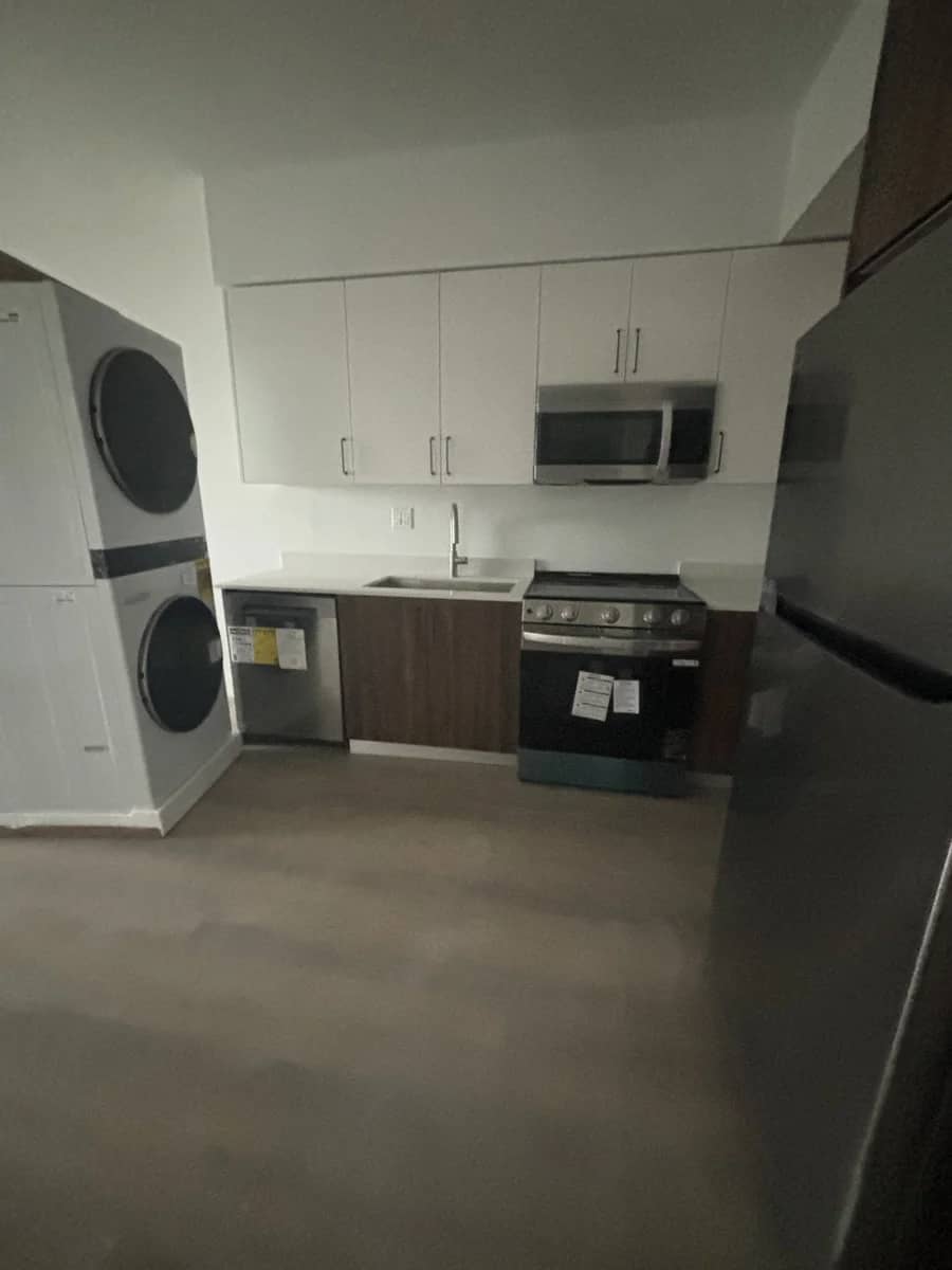 Aventura Quattro, photographed 15 December 2025: finished kitchen with appliances and stacked laundry.