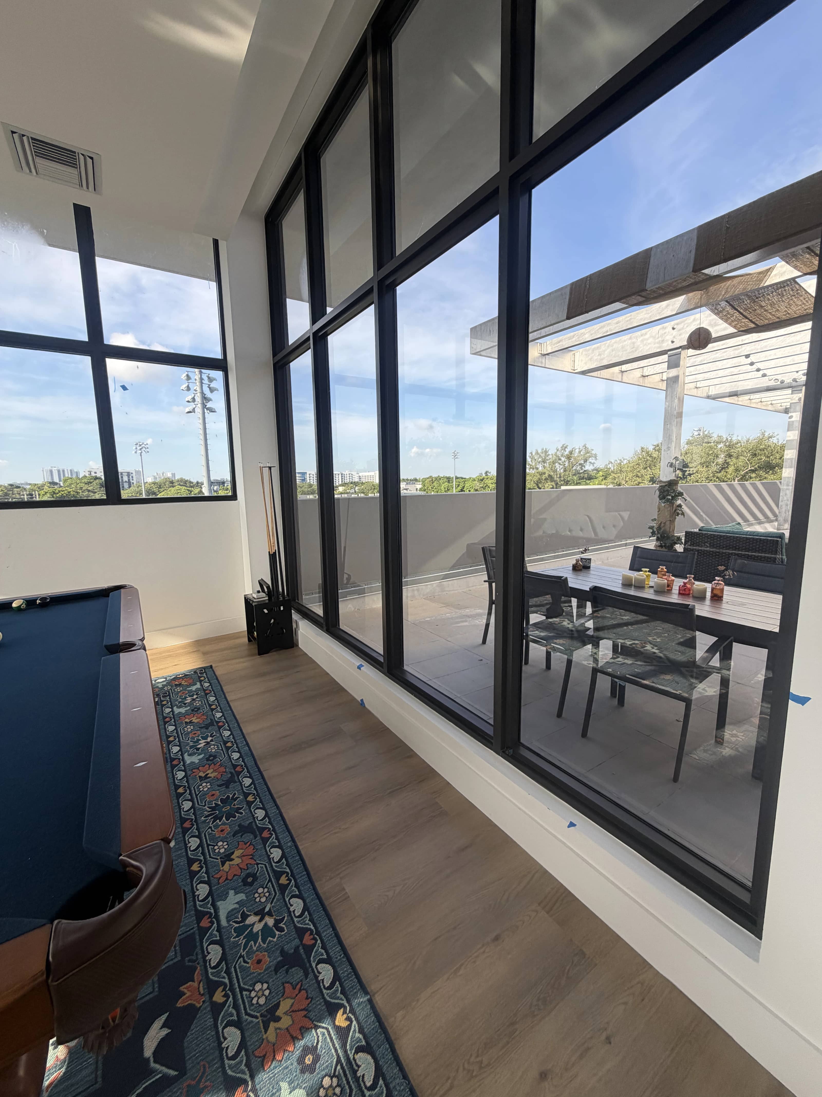 Aventura Quattro, photographed 2 July 2026: furnished residents' room opening onto the roof terrace.
