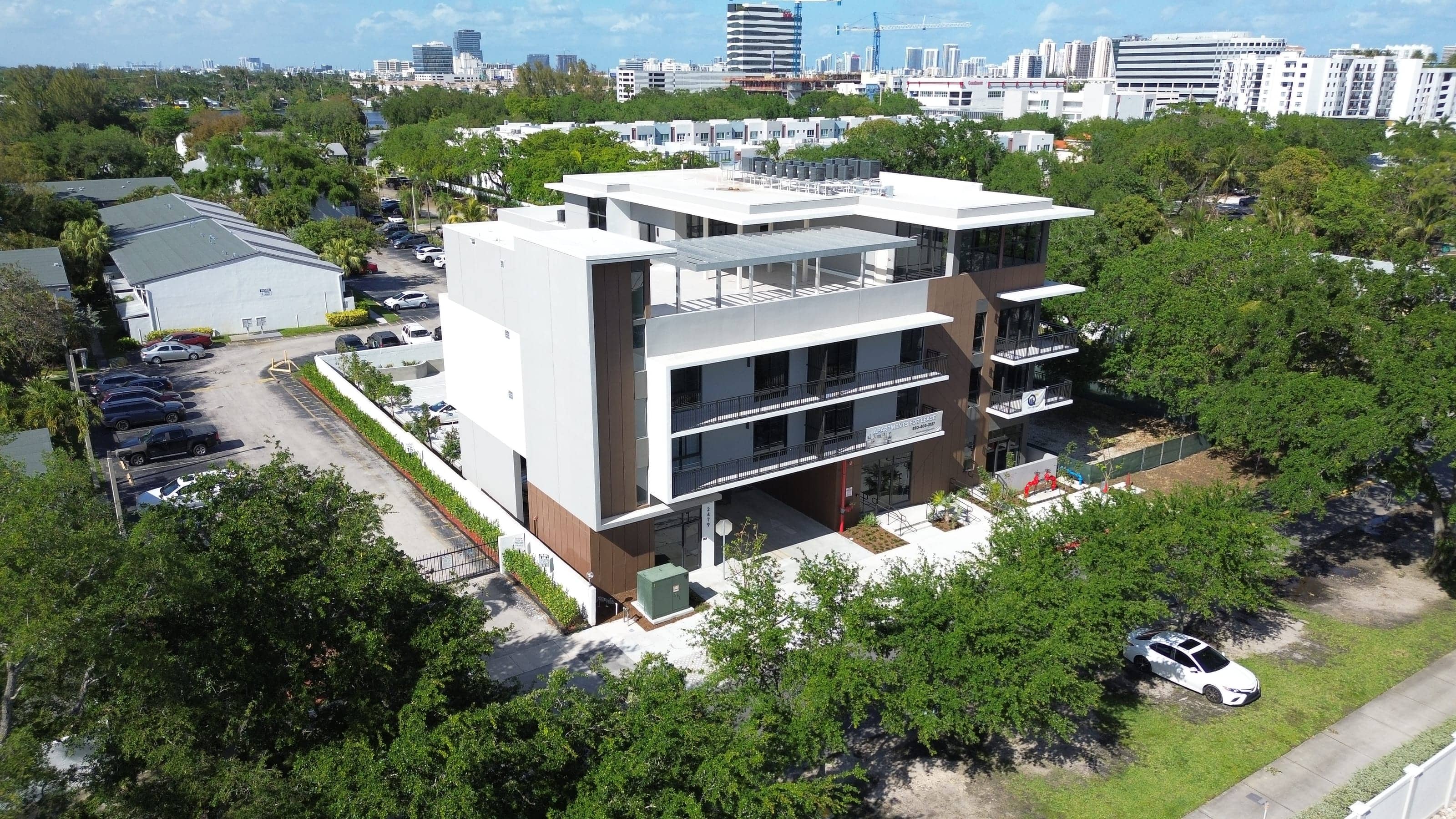 Aerial photograph of the block, with the Aventura skyline behind.